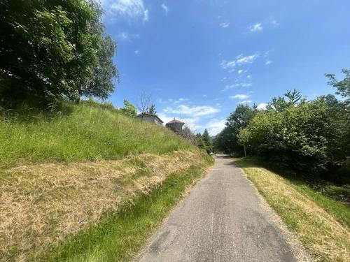 a dirt road next to a grassy hill at Gite La Miellerie in Fellering
