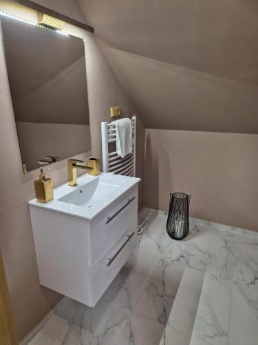 a white bathroom with a sink and a mirror at Penzion Solid Spa in Mladá Boleslav