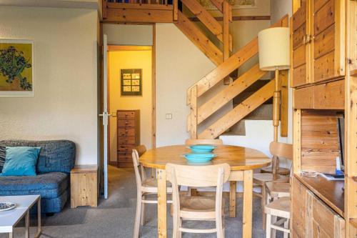 une salle à manger avec une table et un canapé dans l'établissement Résidence Cheval Blanc G - CHEVAL BLANC C74 MAE-3841, à Valmorel