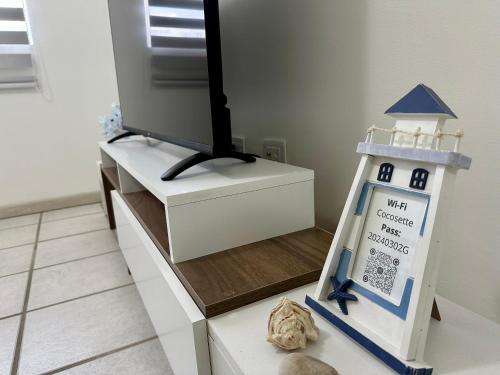 a model of a lighthouse sitting on a tv stand at Posada Azafran en Choroni in Choroní
