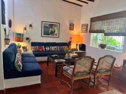 a living room with a blue couch and chairs at Posada Azafran en Choroni in Choroní