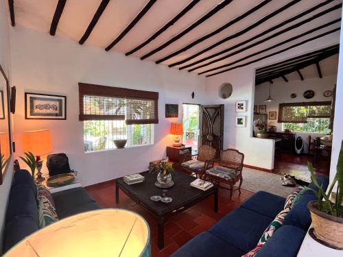 a living room with a blue couch and a table at Posada Azafran en Choroni in Choroní