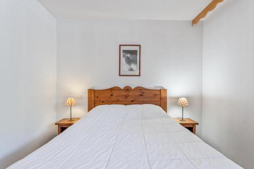 une chambre avec un grand lit blanc avec deux lampes dans l'établissement Résidence Les Hauts De Preclaux - Appartement en rez-de-jardin aux Orres 1800 MAE-3721, aux Orres