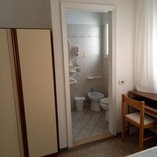 a bathroom with a toilet and a sink at Hotel Serafini Misano Adriatico in Misano Adriatico