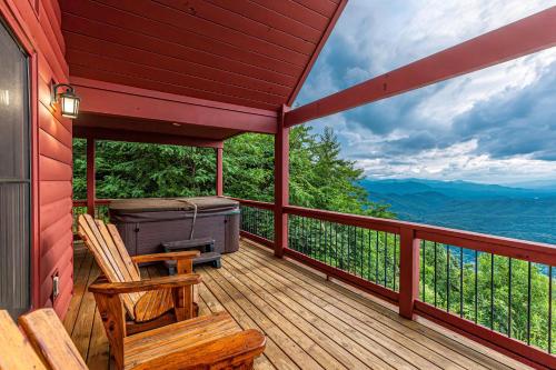 a deck with a chair and a grill on it at A Bear`s Retreat in Bryson City