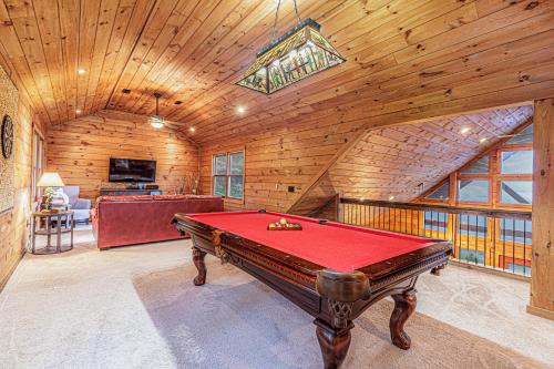 a pool table in a room with wooden walls at A Bear`s Retreat in Bryson City