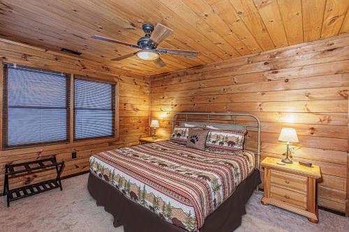 a bedroom with a bed and a ceiling fan at A Bear`s Retreat in Bryson City