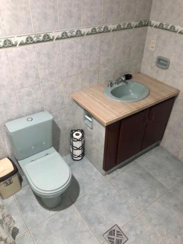 a bathroom with a toilet and a sink at Chez AriCo, Cochabamba in Calacala