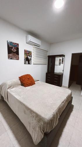 a bedroom with a large bed and a dresser at Casa de Huesped Sky Blue Barranquilla Colombia in Ciudad Jardín
