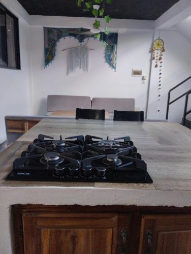 a stove top in a kitchen with a counter at Casa Santa la laguna in La Aguada