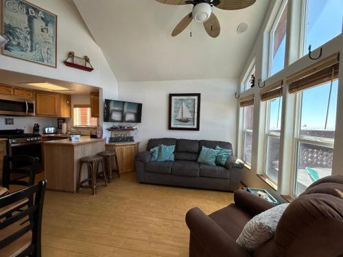 a living room with a couch and a kitchen at Ocean Front Cabin 11 W Jacuzzi & Superb Views in Smith River