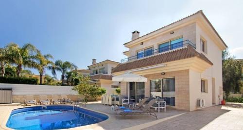 a house with a swimming pool in front of it at Sonja in Paralimni