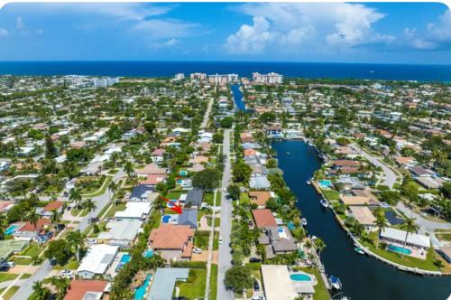 an aerial view of a city next to the ocean at Amazing Home w Heated Pool 8 mins to the Beach in Lighthouse Point