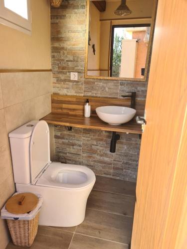 a bathroom with a toilet and a sink at Villa Marovi Bonalba in Alicante