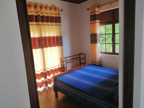 un dormitorio con una cama y una ventana en Ella Paradise, en Passara