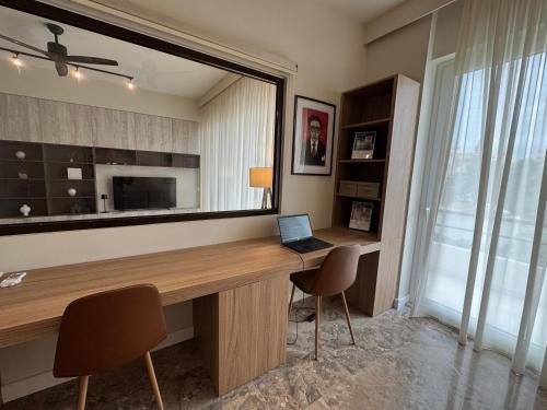 a room with a desk with a laptop and a large mirror at Modern, chic, near a Blue Flag beach, 100 sq m in Korinthos