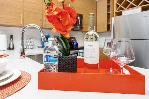 a bottle of wine and a glass on a kitchen counter at Uptown Elegance Gym, Pool, Wine in Charlotte