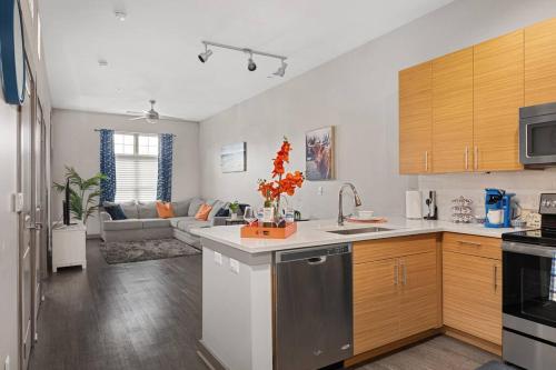 a kitchen and a living room with a couch at Uptown Elegance Gym, Pool, Wine in Charlotte