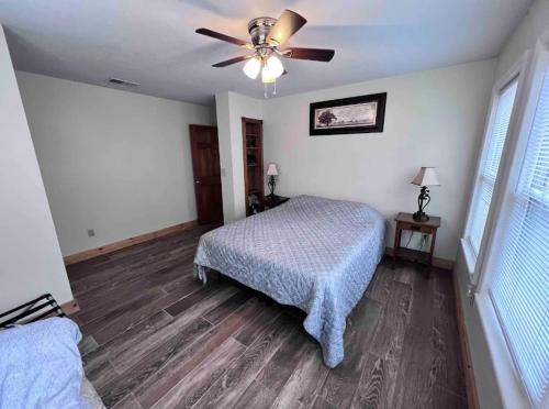 a bedroom with a bed and a ceiling fan at Moonshine Creek Too in Bryson City