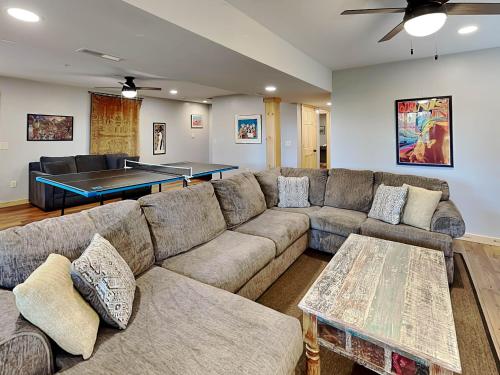 a living room with a couch and a ping pong table at Woods-Stock in McHenry