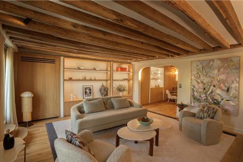 un salon avec un canapé et une table dans l'établissement Luxueux Appartement, avec terrasse vue Champs-Élysées, à Paris