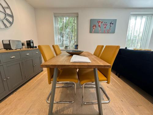 a kitchen with a wooden table and four chairs at Spacious & light 2bed, 2bath in the heart of Windsor in Windsor