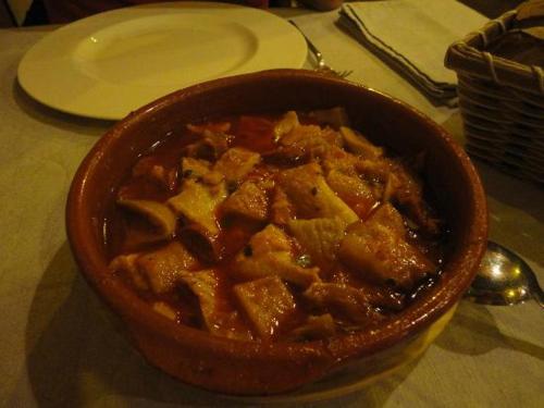 a bowl of food sitting on top of a table at Hostal Los Oteros in Pajares de los Oteros