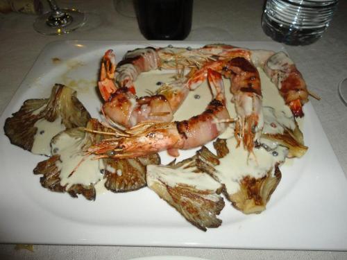 a plate of shrimp and other food on a table at Hostal Los Oteros in Pajares de los Oteros