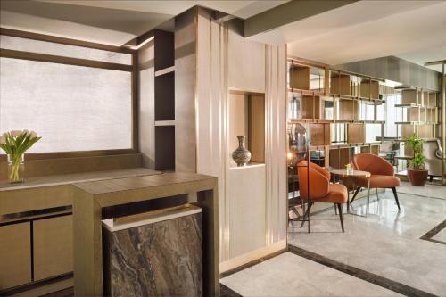 a living room with a fireplace and a dining room at Al Ahsa InterContinental by IHG in Al Ahsa