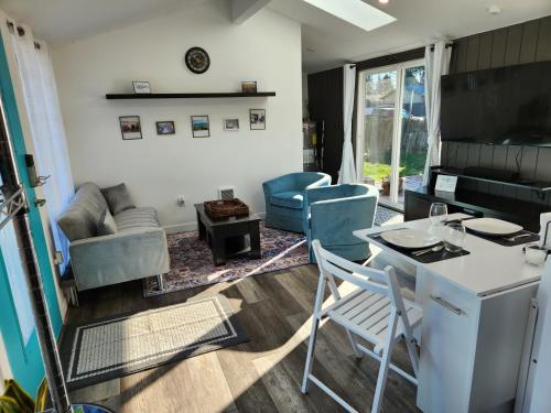 a kitchen and living room with a table and chairs at It's Springtime in the PNW, come on out and enjoy! in Hillsboro