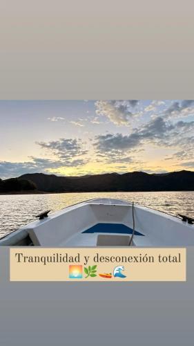a boat on a body of water with the words transmitted by observation total at Cabaña de Lujo, Isla El Faro in Prado