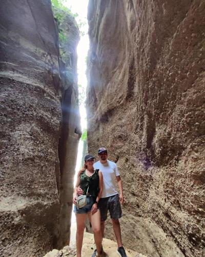 a man and woman standing in a slot canyon at Cabaña de Lujo, Isla El Faro in Prado