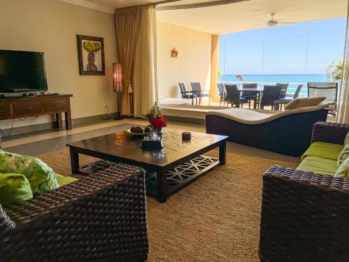 a living room with a couch and a coffee table at Luxury oceanfront condo, enjoy it ! in Cabarete