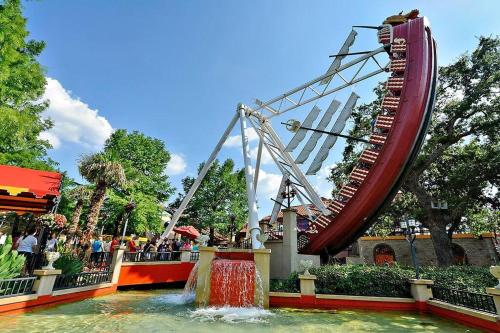 a roller coaster in a amusement park with a water slide at Spacious 4-bedroom house with AC, Wi-Fi superb in the Heart of Arlington, TX! in Johnsons Station