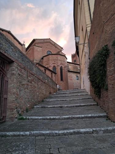 an alley with stone steps in front of a building at Hotel Minerva in Siena