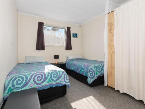 Letto o letti in una camera di Ruakaka Holiday Escape - Ruakaka Holiday Home