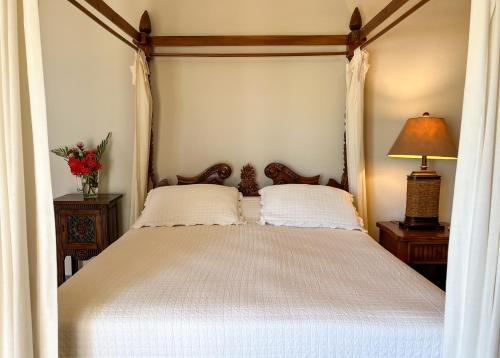 a bedroom with a white bed with a canopy at Luxury oceanfront condo, enjoy it ! in Cabarete