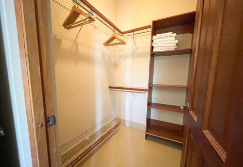a walk in closet with shelves and a door at Luxury oceanfront condo, enjoy it ! in Cabarete