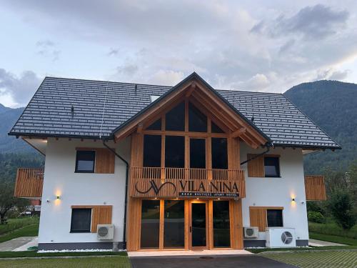 a building with a sign on the front of it at Vila Nina Bohinj in Bohinj