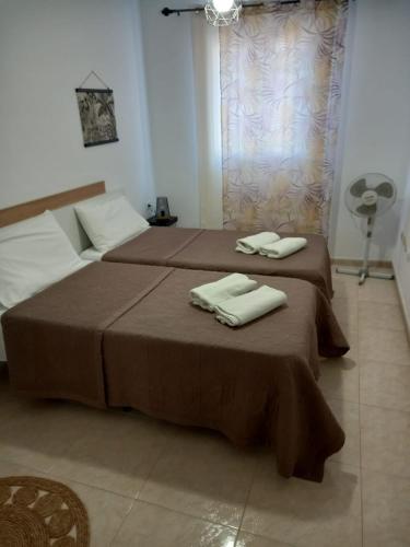 two beds with towels on top of them in a room at APARTAMENTO EL RINCÓN in La Restinga