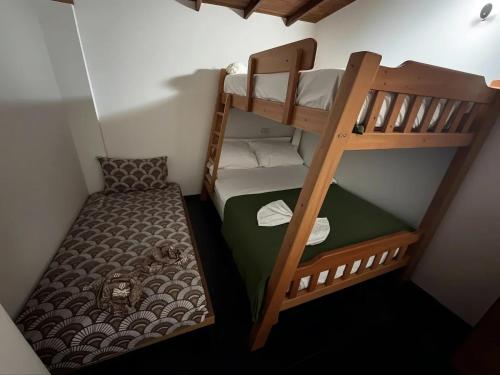 two bunk beds in a small room with a bed at Aparta Suites Torre de Prado 501 Apartamento para 7 Personas in Medellín