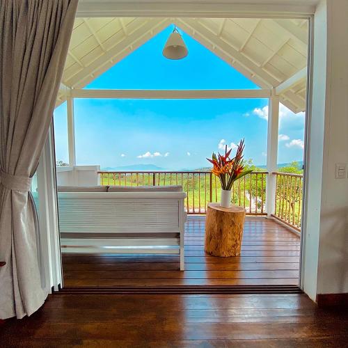 a porch with a bench and a view of the ocean at Finca San Cayetano in San Juan Alotenango