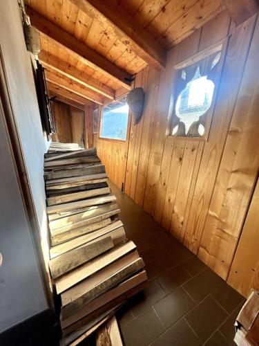an inside view of a cabin with stairs in it at La Mansarda di Laura a Danta in Danta