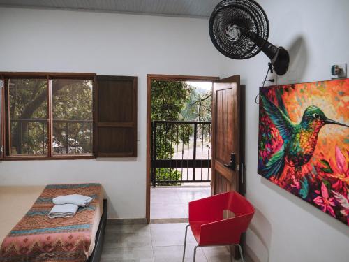 a room with a painting of a bird on the wall at Coffee House Minca in Minca