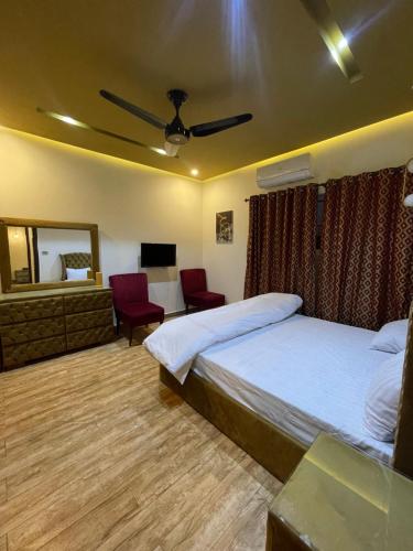 a hotel room with two beds and a mirror at Fellows BnB in Dhok Sandemār