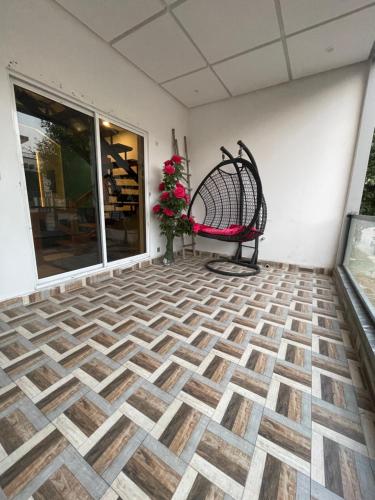 a empty porch with a bench on a tiled floor at Fellows BnB in Dhok Sandemār