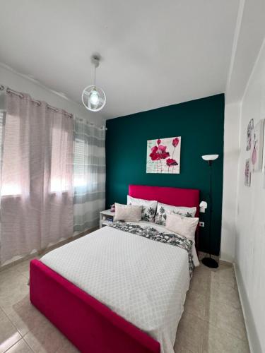 a bedroom with a large bed and a green wall at Charmant appartement á Tanger in Tangier