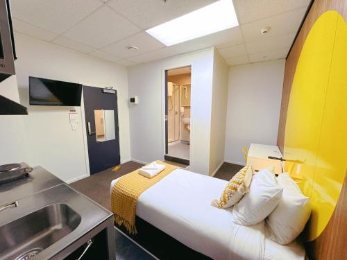 a hotel room with a bed and a sink at Wellington Hotel in Wellington