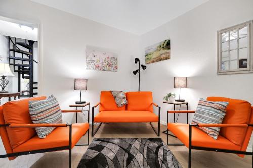 a living room with orange chairs and lamps at Box 3- A Birdy Vacation Rental in Fair Oaks Ranch