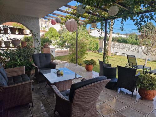 a patio with chairs and a table with a view at El Camarote in Mijas